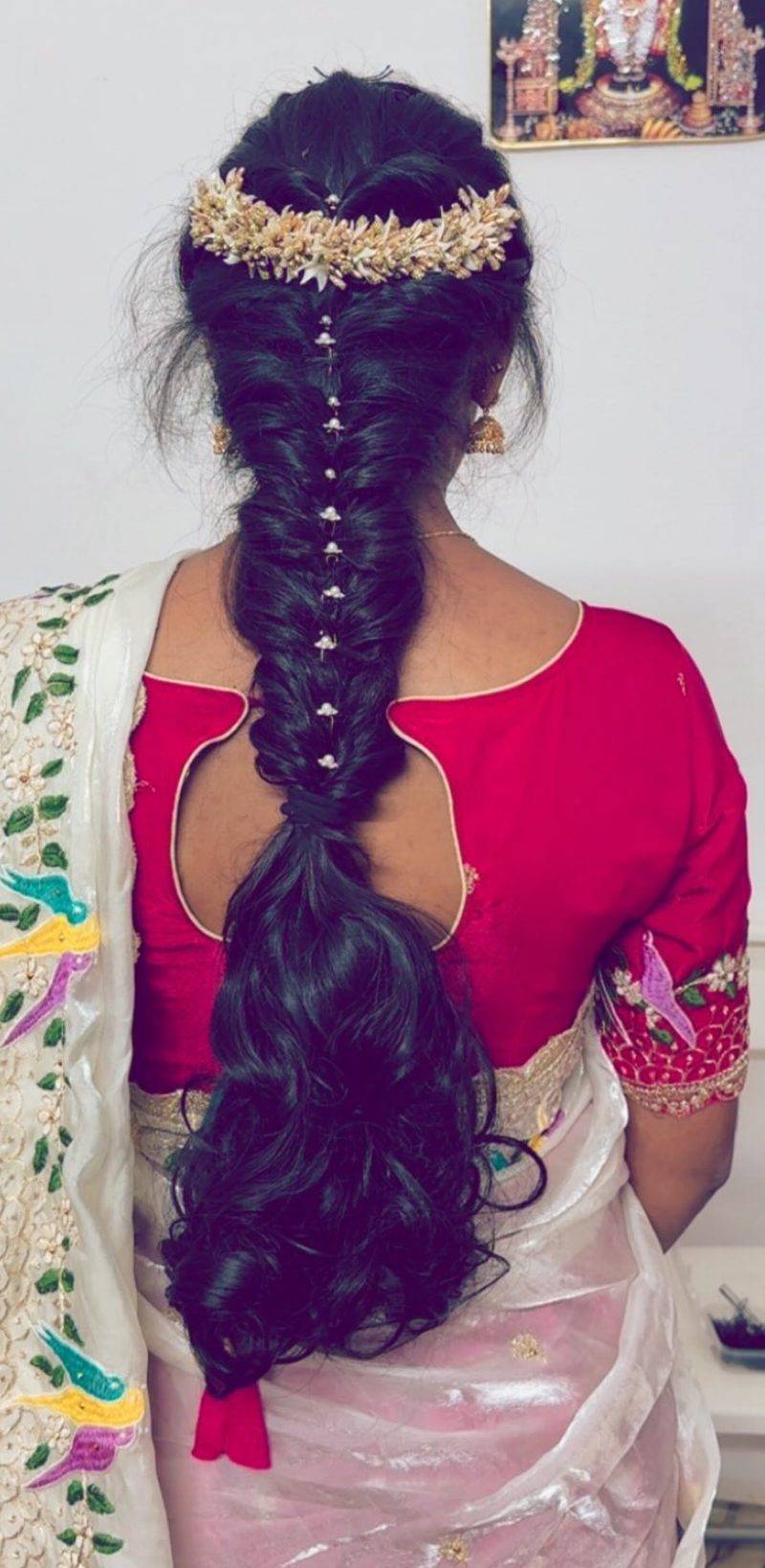 Fishtail braid bridal hairstyle with fresh flowers by House of Yuktha